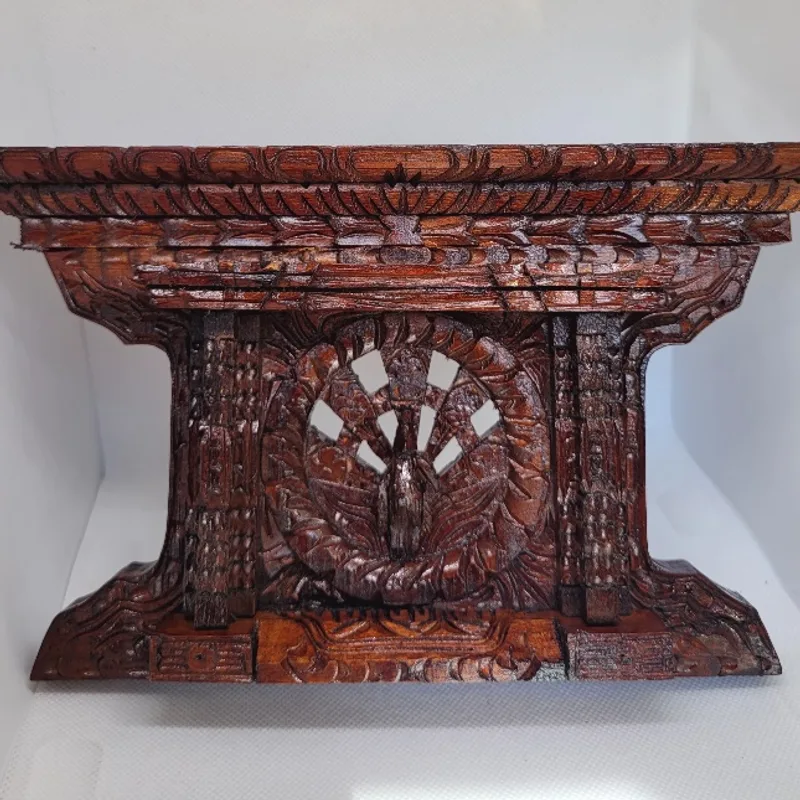 Carved timber temple bracket with a pierced peacock medallion