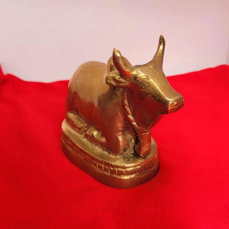 Solid brass Nandi bull seated on a moulded plinth