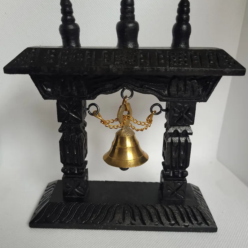 Hand-carved blackwood torana stand with a brass bell hung on chain