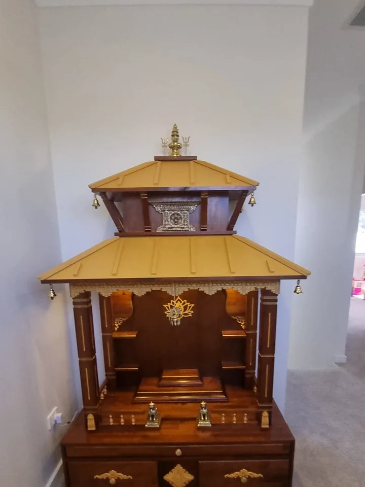 Brown Japan pagoda mandir with twin gold roofs and a gilded lotus om pendant